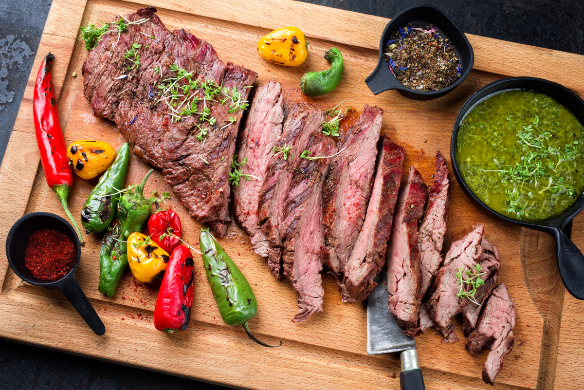 Sliced Mexican meat on a cutting board with other ingredients in El Paso.